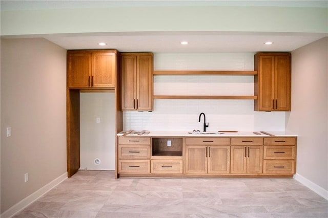 12820 N Arbor Way, Platte City, MO 64079 - kitchen featuring open shelves, light countertops, brown cabinetry, recessed lighting, and backsplash