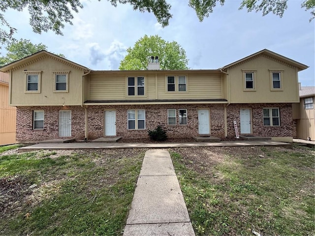 401-07 NE Highland Ln, Blue Springs, MO 64014 - townhome / multi-family property featuring a patio area, brick siding, and a chimney