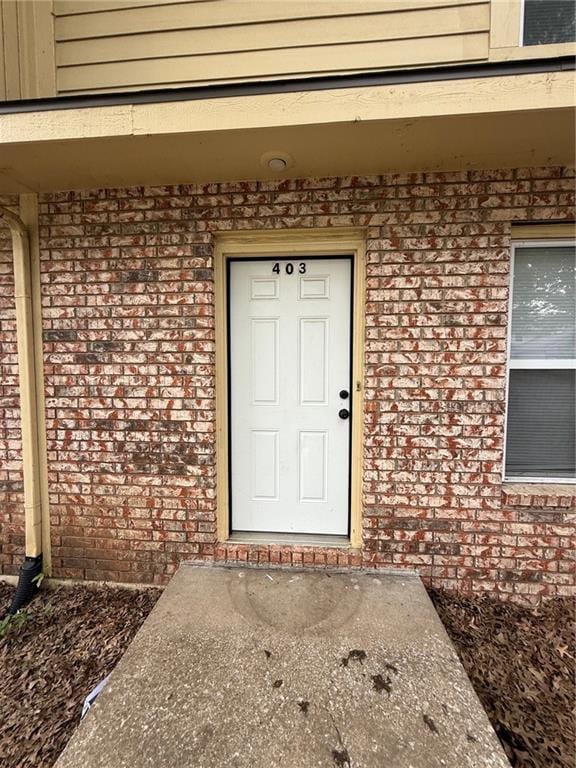 401-07 NE Highland Ln, Blue Springs, MO 64014 - doorway to property featuring brick siding