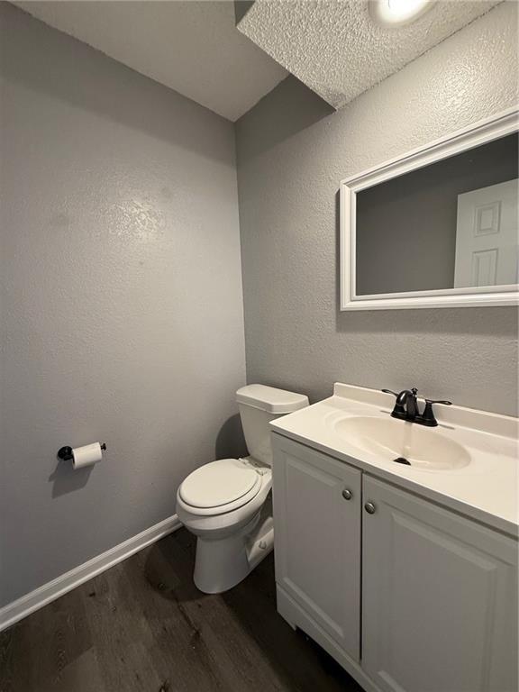401-07 NE Highland Ln, Blue Springs, MO 64014 - bathroom featuring wood finished floors and vanity