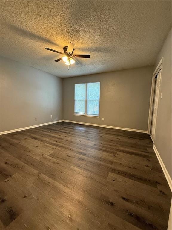 401-07 NE Highland Ln, Blue Springs, MO 64014 - spare room featuring dark wood-style floors, ceiling fan, and a textured ceiling