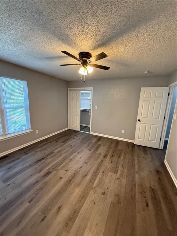 401-07 NE Highland Ln, Blue Springs, MO 64014 - spare room with dark wood-style flooring, ceiling fan, and a textured ceiling