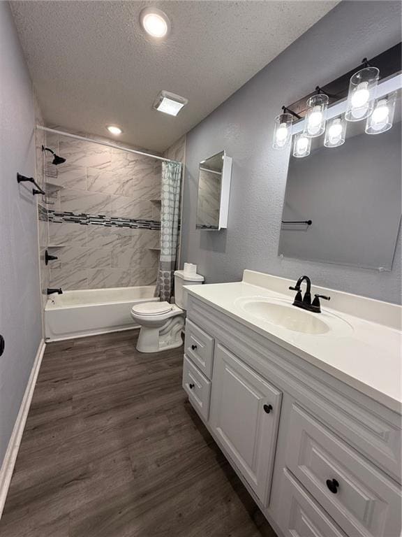401-07 NE Highland Ln, Blue Springs, MO 64014 - bathroom with a textured ceiling, shower / tub combo, vanity, wood finished floors, and recessed lighting