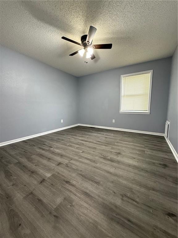 401-07 NE Highland Ln, Blue Springs, MO 64014 - empty room featuring a textured ceiling, a ceiling fan, and dark wood-style floors