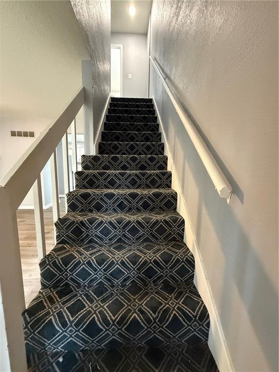 401-07 NE Highland Ln, Blue Springs, MO 64014 - stairs with baseboards