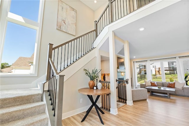 2768 SW 12th Ter, Lees Summit, MO 64081 - stairs featuring wood finished floors, a towering ceiling, and recessed lighting