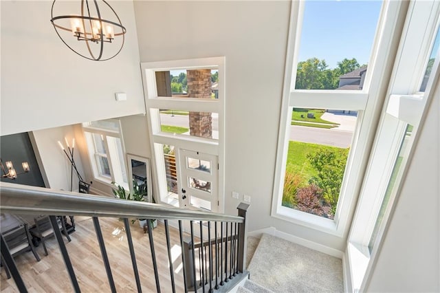2768 SW 12th Ter, Lees Summit, MO 64081 - stairway featuring a chandelier and healthy amount of natural light