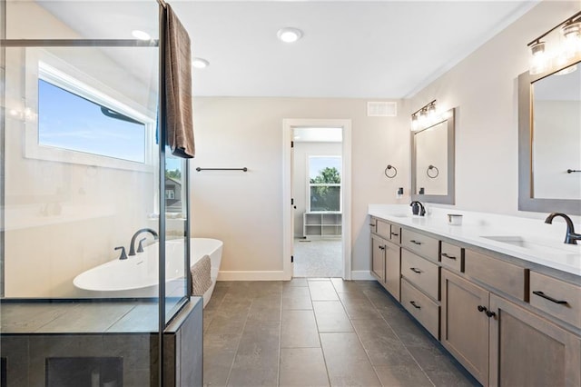 2768 SW 12th Ter, Lees Summit, MO 64081 - bathroom with double vanity, a freestanding bath, and recessed lighting