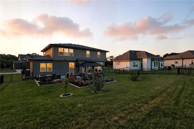 2768 SW 12th Ter, Lees Summit, MO 64081 - back of property at dusk featuring a gazebo, an outdoor hangout area, a fenced backyard, and a patio area