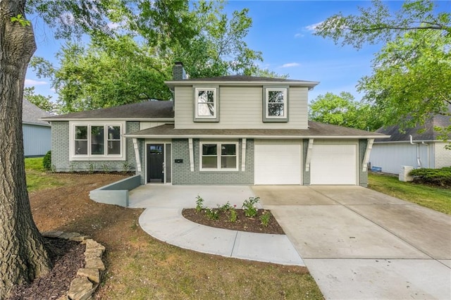 9909 Juniper Ln, Overland Park, KS 66207 - split level home with a chimney, brick siding, driveway, and a garage