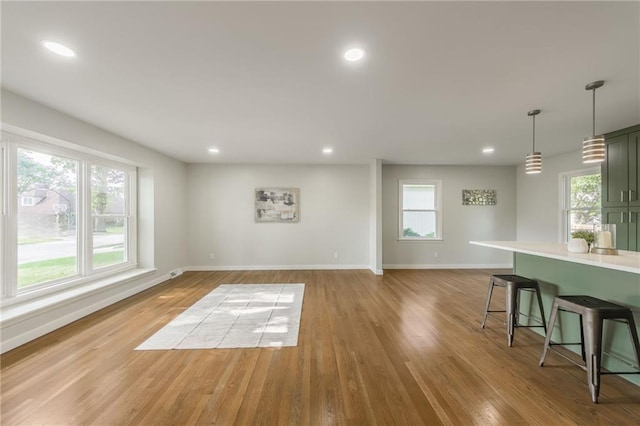 9909 Juniper Ln, Overland Park, KS 66207 - unfurnished living room with light wood-style flooring and recessed lighting