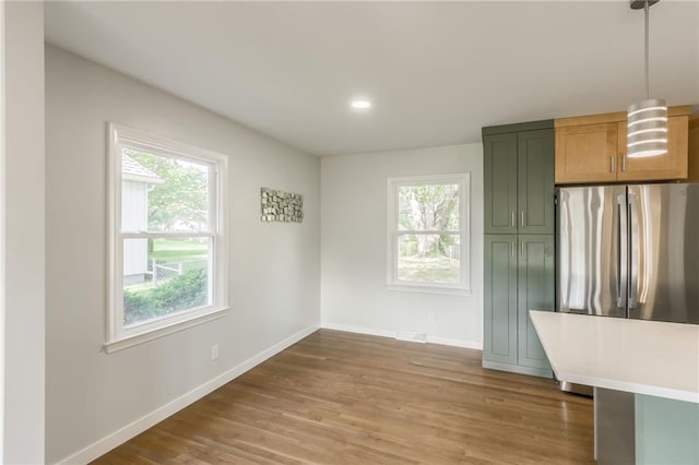 9909 Juniper Ln, Overland Park, KS 66207 - unfurnished dining area with plenty of natural light, light wood finished floors, and recessed lighting