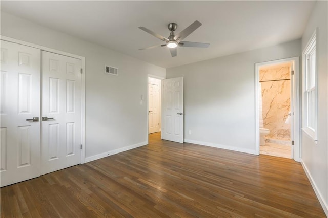 9909 Juniper Ln, Overland Park, KS 66207 - unfurnished bedroom with wood finished floors, a closet, ensuite bath, and ceiling fan