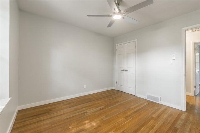 9909 Juniper Ln, Overland Park, KS 66207 - unfurnished bedroom featuring light wood finished floors, a closet, and ceiling fan