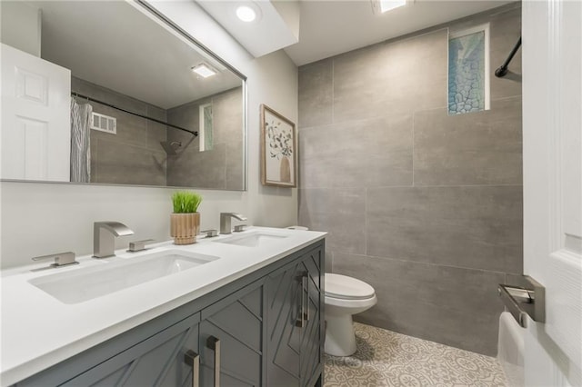 9909 Juniper Ln, Overland Park, KS 66207 - bathroom with curtained shower, double vanity, tile patterned flooring, and tile walls