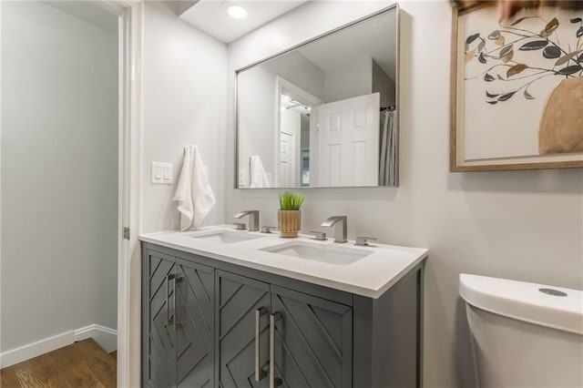 9909 Juniper Ln, Overland Park, KS 66207 - full bath with double vanity and wood finished floors
