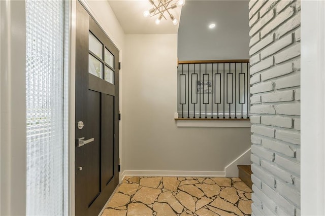 9909 Juniper Ln, Overland Park, KS 66207 - entrance foyer featuring a chandelier and baseboards