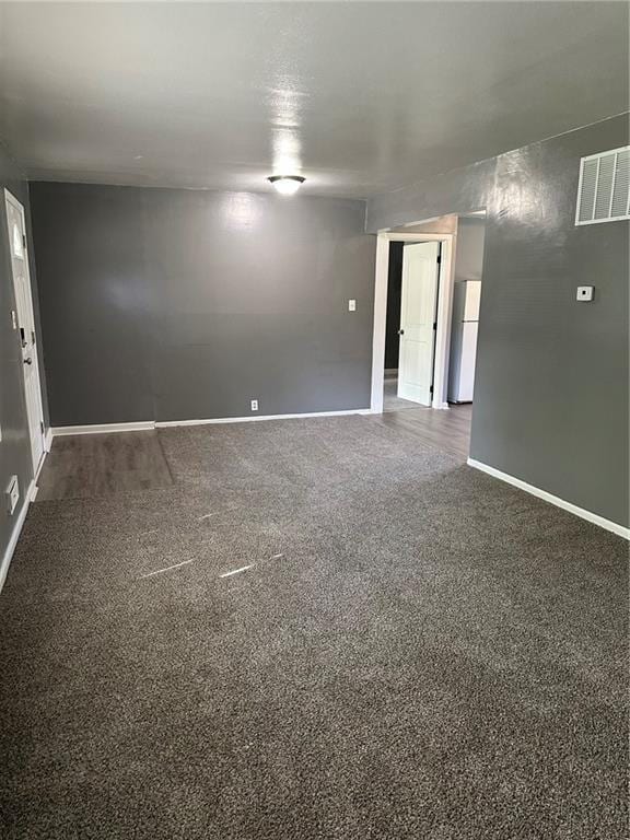 11001 Ewing Ave, Kansas City, MO 64134 - empty room with baseboards and dark carpet