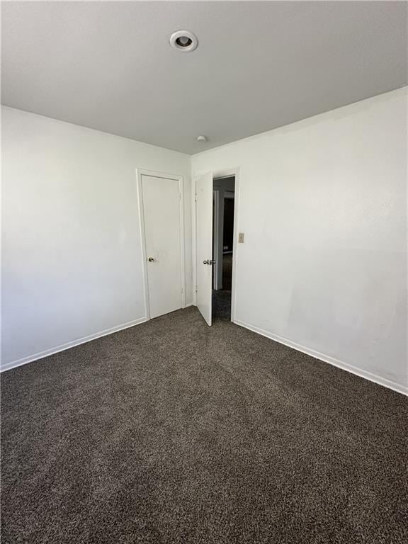 11001 Ewing Ave, Kansas City, MO 64134 - unfurnished room with dark carpet and recessed lighting