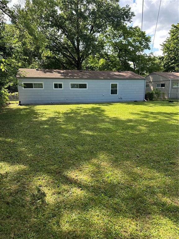11001 Ewing Ave, Kansas City, MO 64134 - back of house featuring a lawn