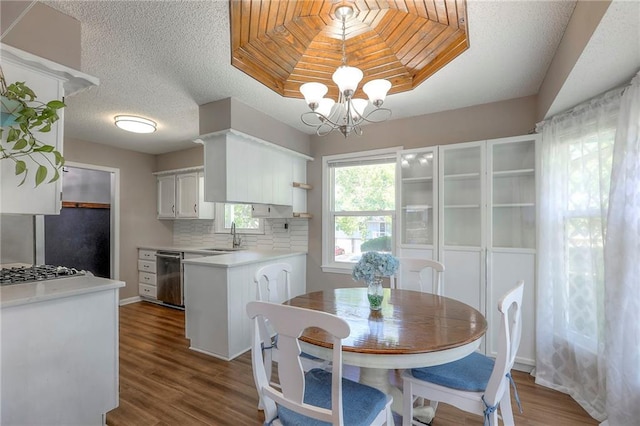 1921 SW 4th St, Lees Summit, MO 64081 - dining area featuring a chandelier, dark wood-style floors, and a textured ceiling