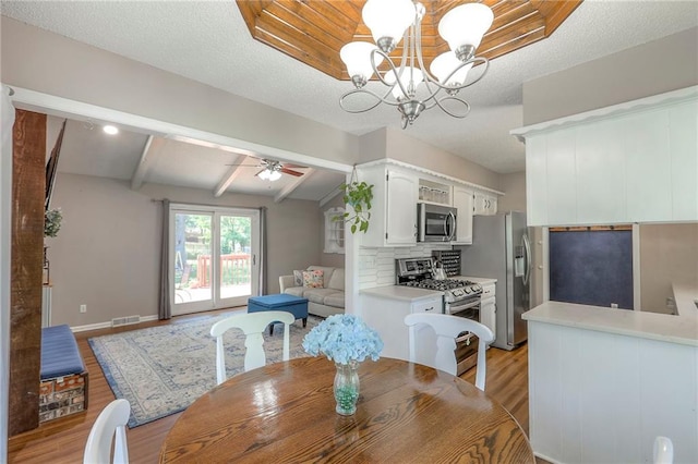 1921 SW 4th St, Lees Summit, MO 64081 - dining space featuring light wood-type flooring, a chandelier, beam ceiling, and a ceiling fan