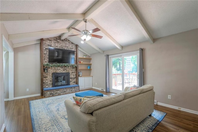 1921 SW 4th St, Lees Summit, MO 64081 - living room with wood finished floors, a ceiling fan, a fireplace, and a textured ceiling