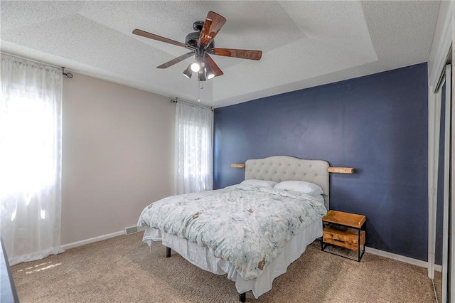 1921 SW 4th St, Lees Summit, MO 64081 - bedroom featuring multiple windows, carpet floors, ceiling fan, and a textured ceiling