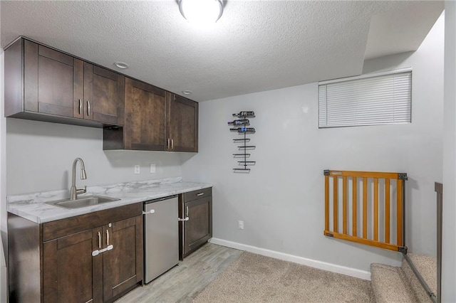 1921 SW 4th St, Lees Summit, MO 64081 - kitchen with stainless steel dishwasher, dark brown cabinetry, a textured ceiling, and light wood-style floors