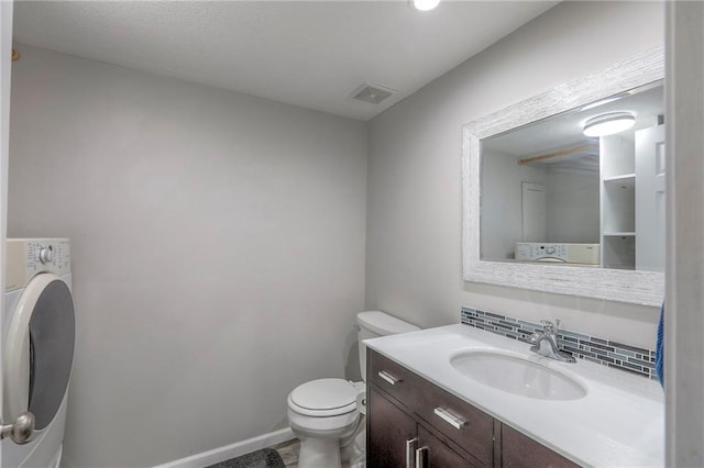 1921 SW 4th St, Lees Summit, MO 64081 - bathroom with washer / dryer, vanity, and tasteful backsplash