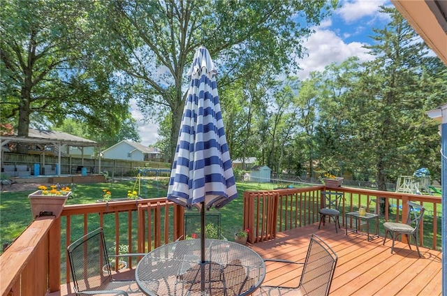 1921 SW 4th St, Lees Summit, MO 64081 - deck featuring outdoor dining area, a fenced backyard, and a playground