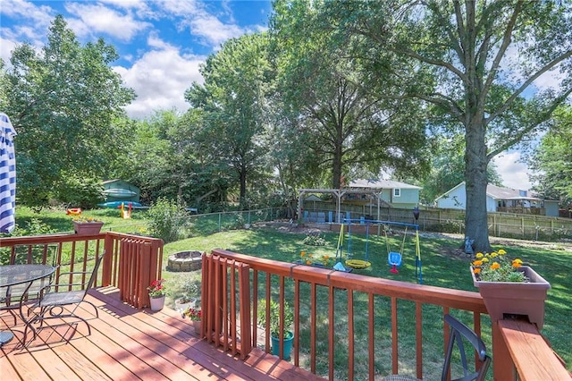 1921 SW 4th St, Lees Summit, MO 64081 - wooden terrace featuring a fire pit, a playground, and a fenced backyard