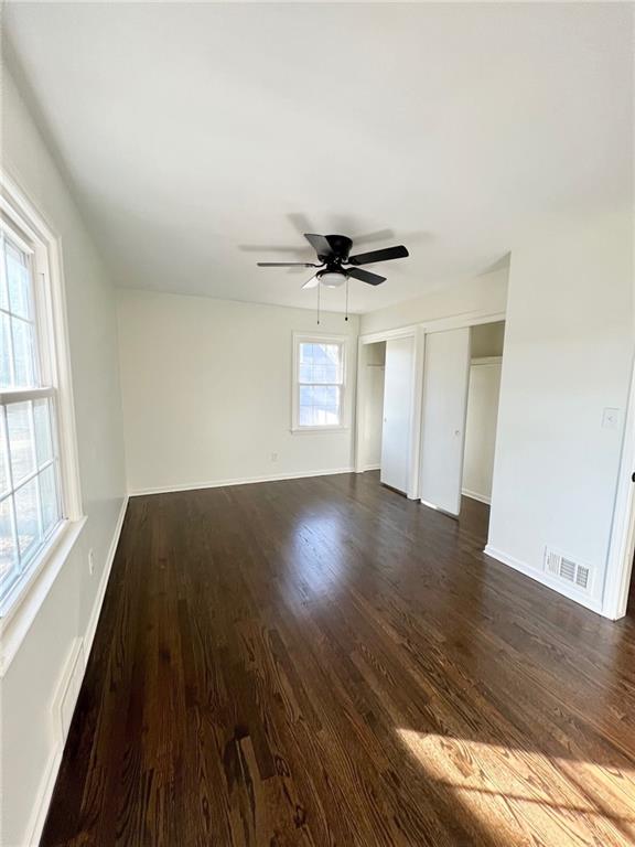 10806 W 96th St, Overland Park, KS 66214 - spare room featuring dark wood-type flooring and ceiling fan
