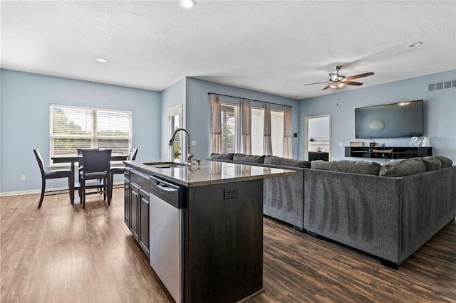 21904 Crystal Ave, Peculiar, MO 64078 - kitchen with stainless steel dishwasher, a ceiling fan, dark wood finished floors, a center island with sink, and recessed lighting