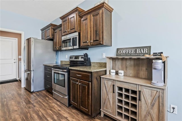 21904 Crystal Ave, Peculiar, MO 64078 - kitchen with appliances with stainless steel finishes, dark brown cabinetry, and dark wood-style flooring