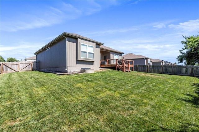 21904 Crystal Ave, Peculiar, MO 64078 - rear view of property featuring a fenced backyard, a deck, a gate, and stairs