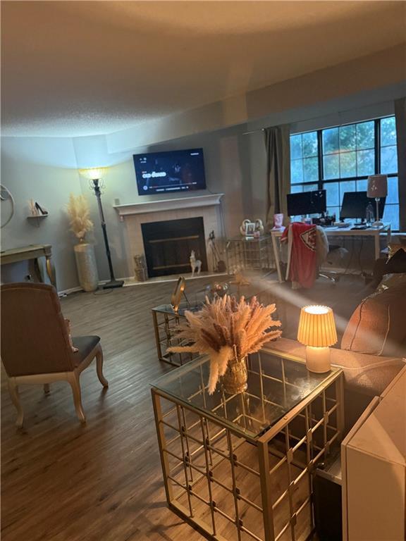 8135 Holmes Rd Unit 202, Kansas City, MO 64131 - living area featuring a fireplace, wood finished floors, and a desk