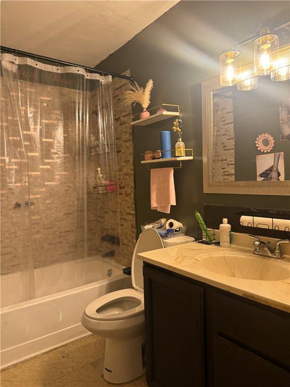 8135 Holmes Rd Unit 202, Kansas City, MO 64131 - full bathroom featuring shower / bath combo with shower curtain, vanity, and tile patterned floors