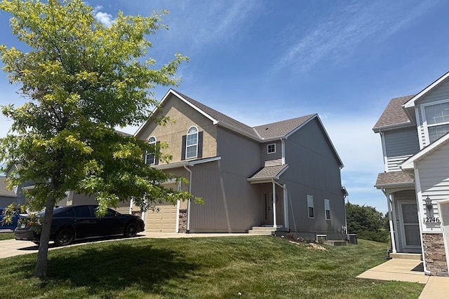 12748 Walker Ave, Kansas City, KS 66109 - view of front of property featuring entry steps, a garage, and a front lawn