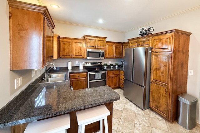 12748 Walker Ave, Kansas City, KS 66109 - kitchen with appliances with stainless steel finishes, a peninsula, brown cabinets, ornamental molding, and a breakfast bar