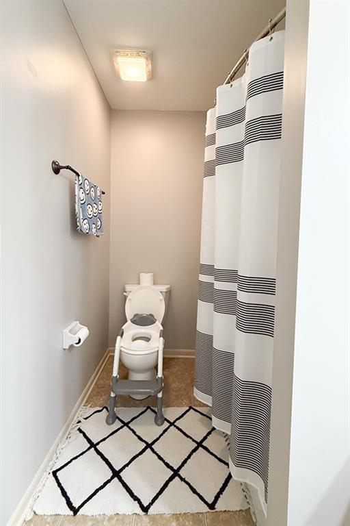 12748 Walker Ave, Kansas City, KS 66109 - full bathroom featuring a heating unit and a shower with shower curtain