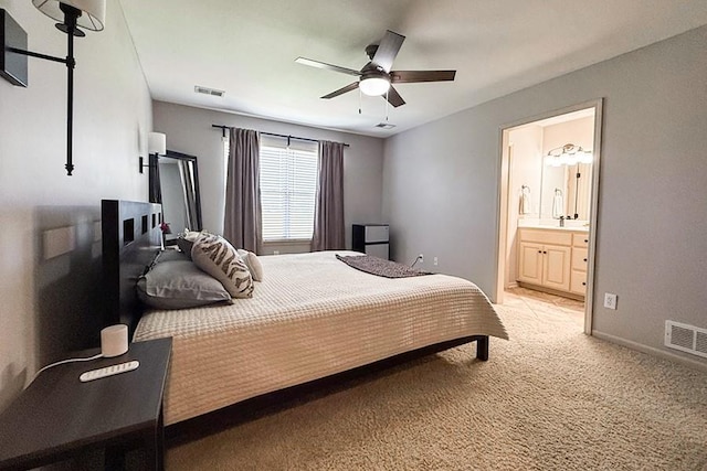 12748 Walker Ave, Kansas City, KS 66109 - bedroom featuring light carpet, connected bathroom, and ceiling fan