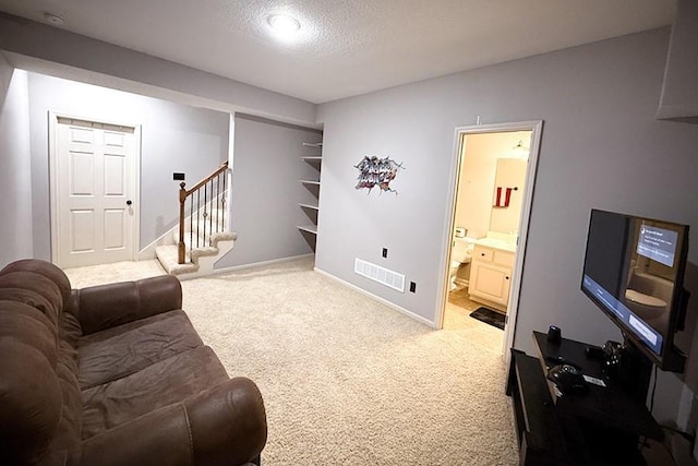 12748 Walker Ave, Kansas City, KS 66109 - carpeted living area featuring stairs and a textured ceiling