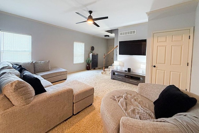 12748 Walker Ave, Kansas City, KS 66109 - living area featuring carpet flooring, stairway, crown molding, and a ceiling fan