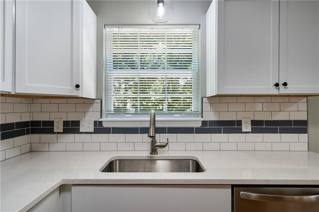 1304 E 41st St, Kansas City, MO 64110 - kitchen featuring dishwasher, white cabinets, backsplash, and light stone counters