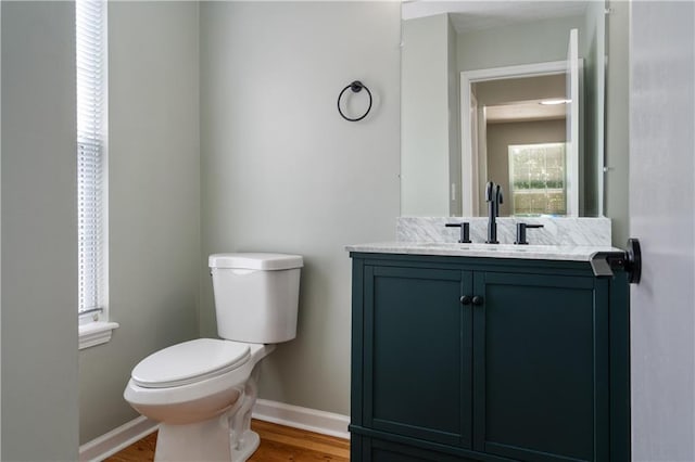 1304 E 41st St, Kansas City, MO 64110 - half bath featuring vanity and wood finished floors