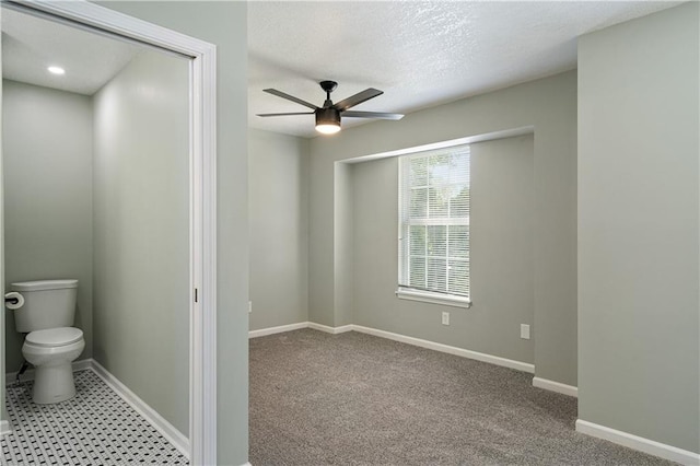 1304 E 41st St, Kansas City, MO 64110 - bathroom featuring a ceiling fan and a textured ceiling