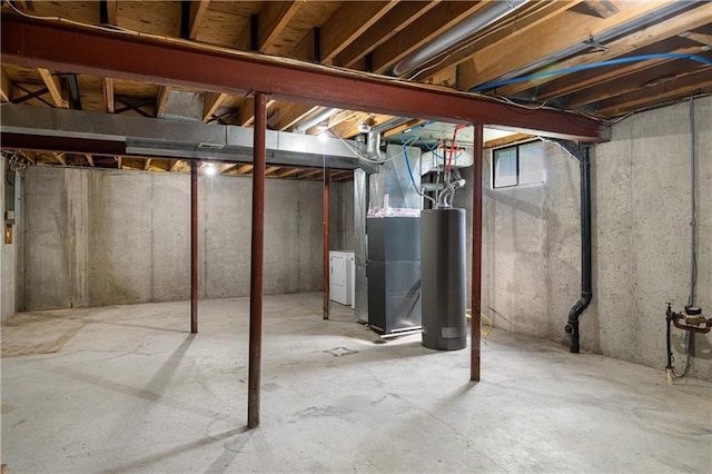1304 E 41st St, Kansas City, MO 64110 - unfinished below grade area featuring water heater, heating unit, and washer / dryer