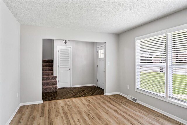 16620 E 36th St, Independence, MO 64055 - foyer with wood finished floors, stairway, and a textured ceiling