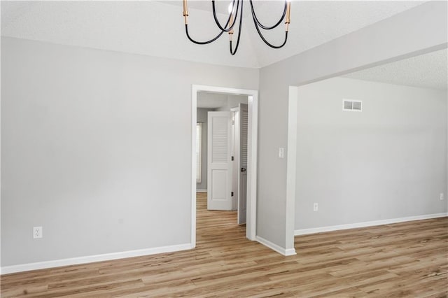 16620 E 36th St, Independence, MO 64055 - empty room featuring a chandelier and light wood finished floors
